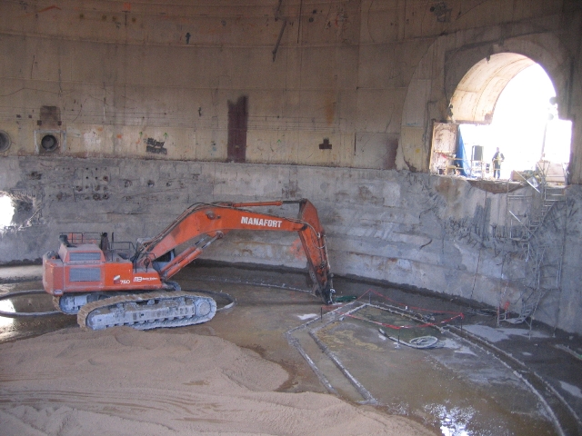 An excavator-cutter working the containment building's interior
